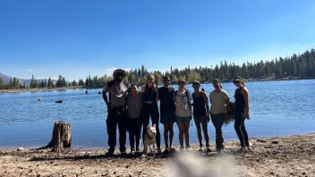 Students featured in front of a lake
