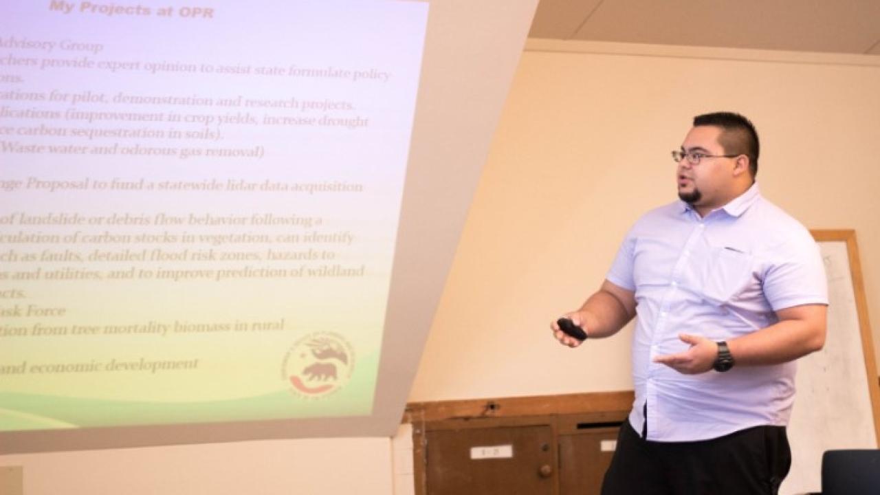 Michael presenting his current job duties and his future career goals to his peers. Michael Maguire student in the Master of Science in Environmental Policy and Management program at University of California, Davis.