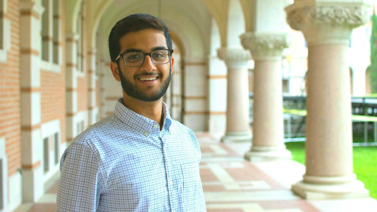 Saurabh Harohalli smiling featured in an outside hallway