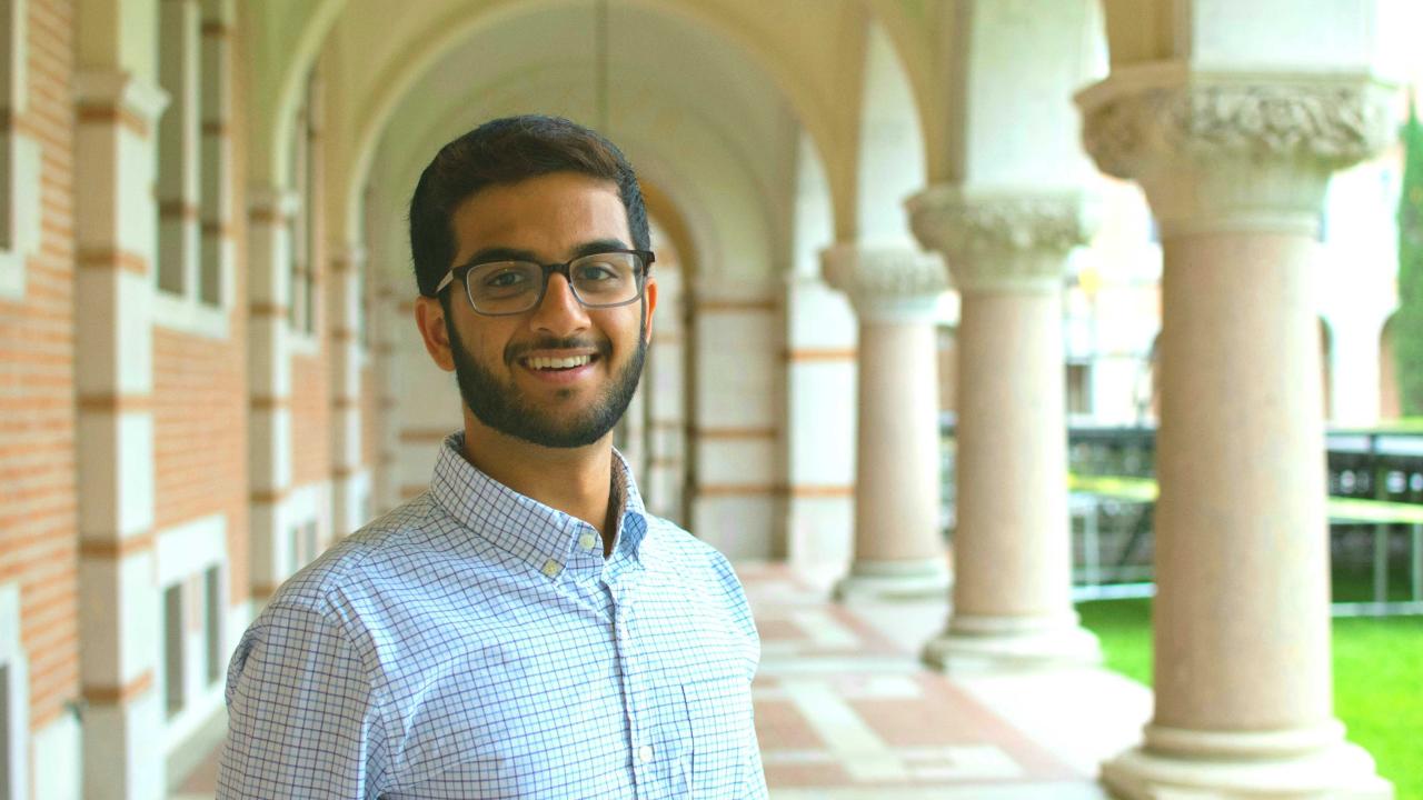 Saurabh Harohalli smiling featured in an outside hallway