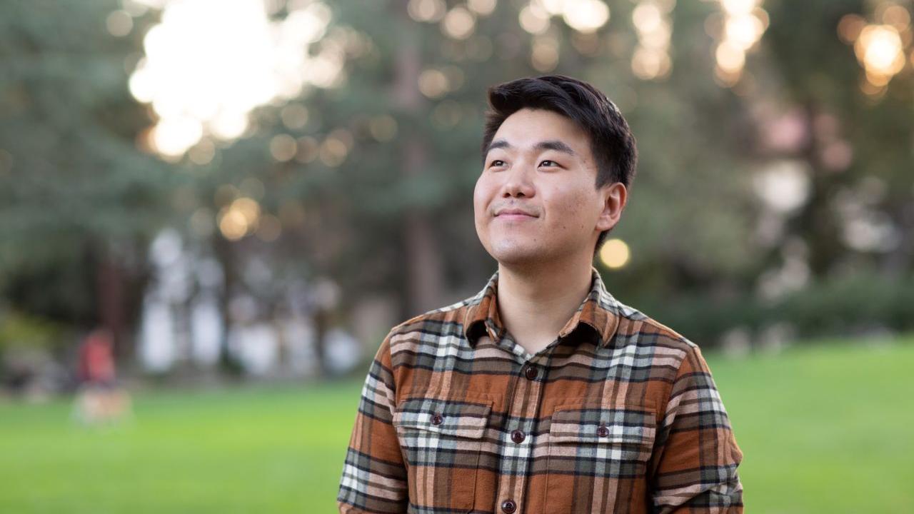 Bilegt Baatar featured smiling with greenery and trees in the background.