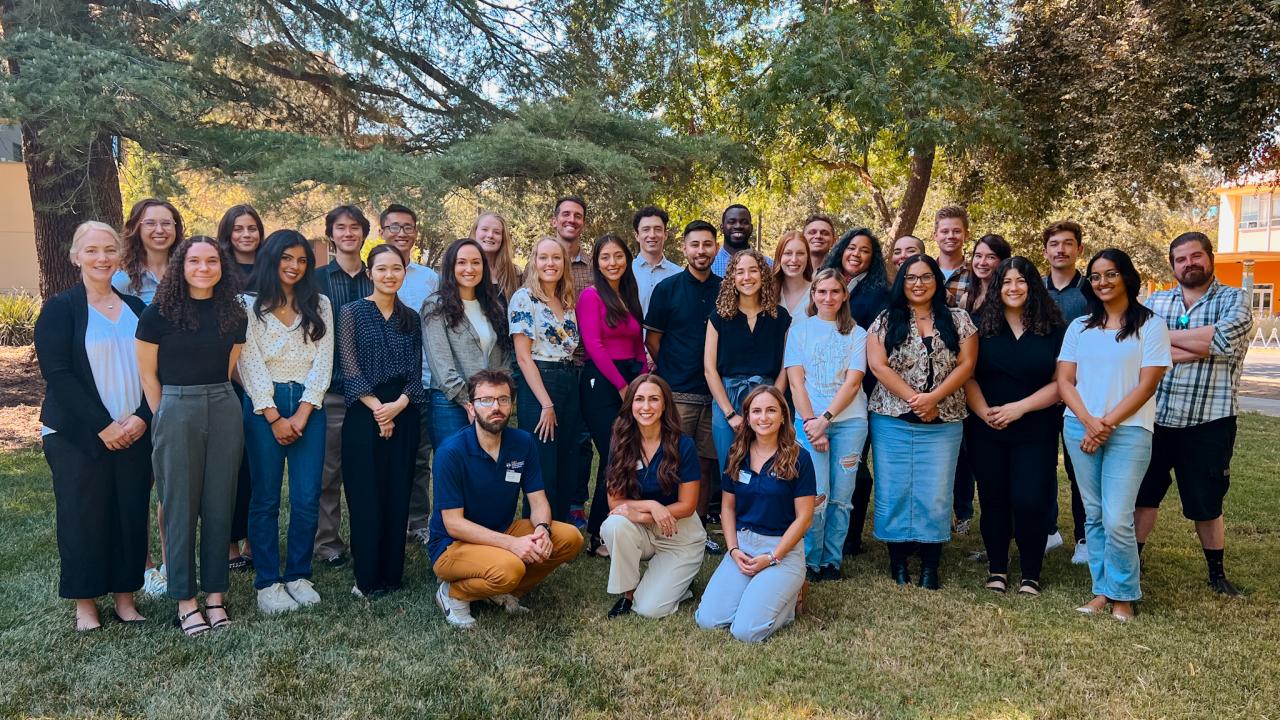 Pictured is the 2023 Incoming Class of Environmental Policy students featured in front of a tree outside of Walker Hall, on campus.