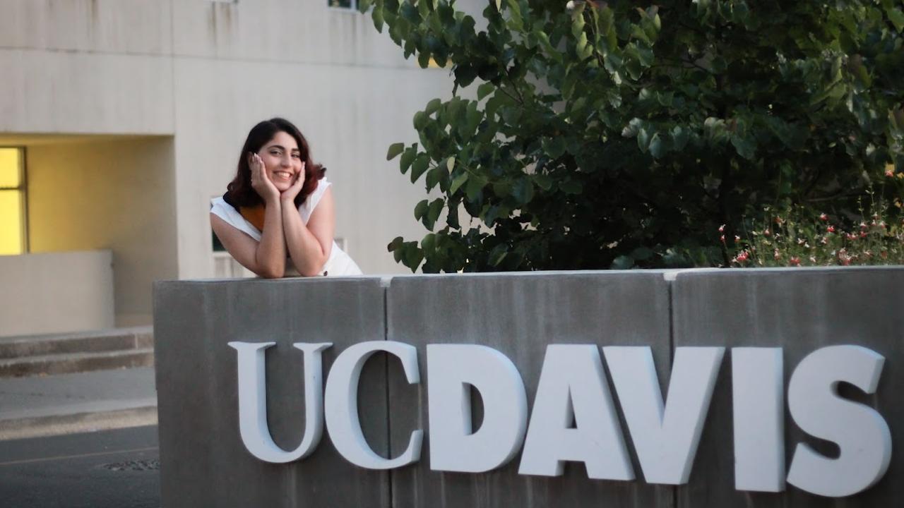 Sara featured in front of the "UC Davis sign"