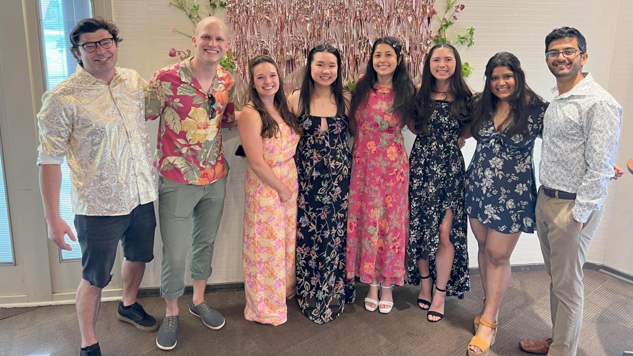 EPM's Social Committee poses in front of EProM decorations