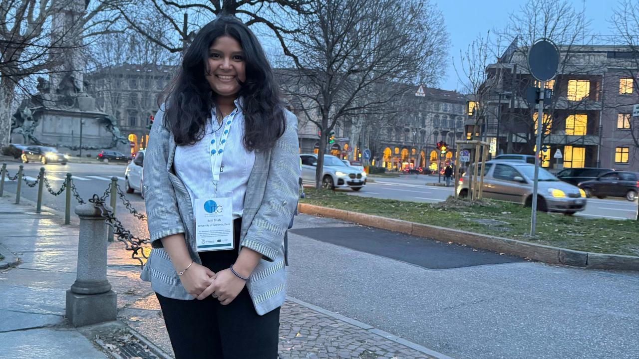 Kriti Shah featured smiling in front of some buildings in Italy