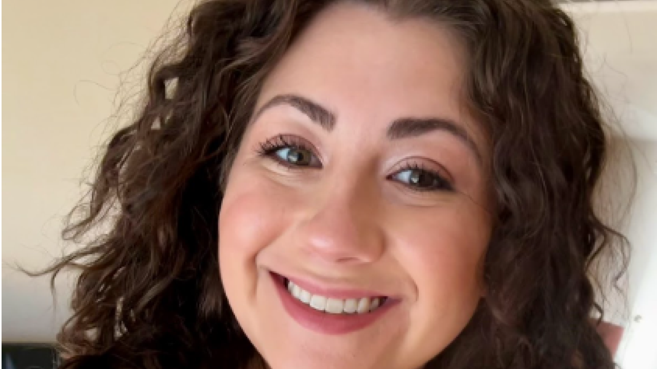 Abbey Gyetvai smiling while taking a selfie.