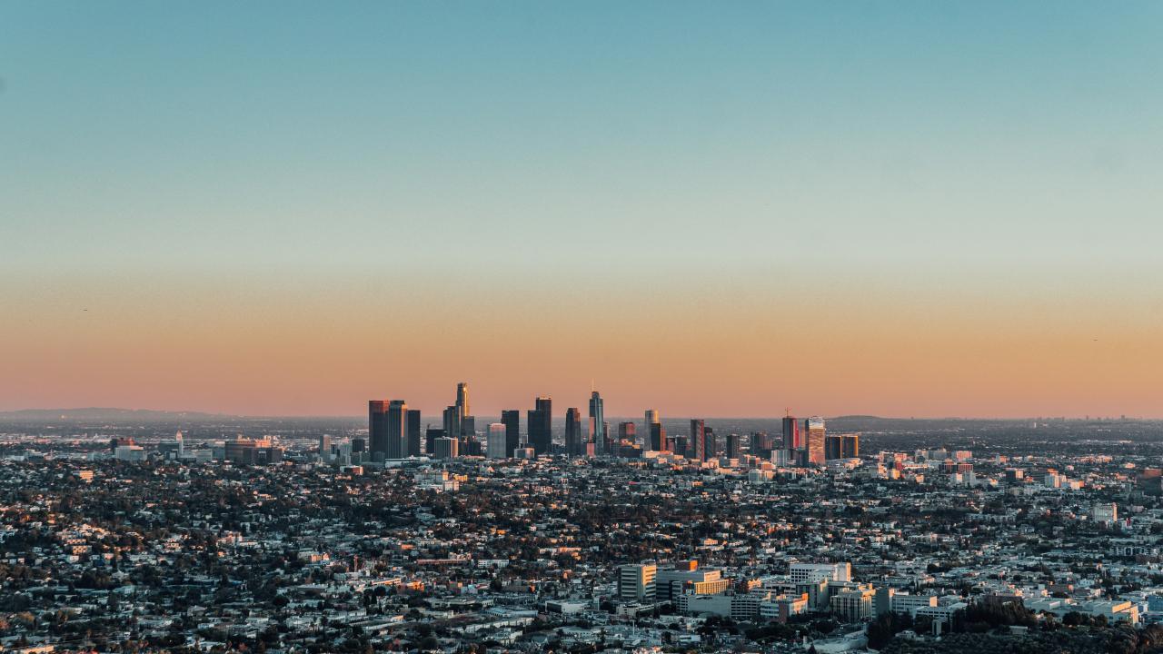 Los Angeles, CA cityscape with sunset in background