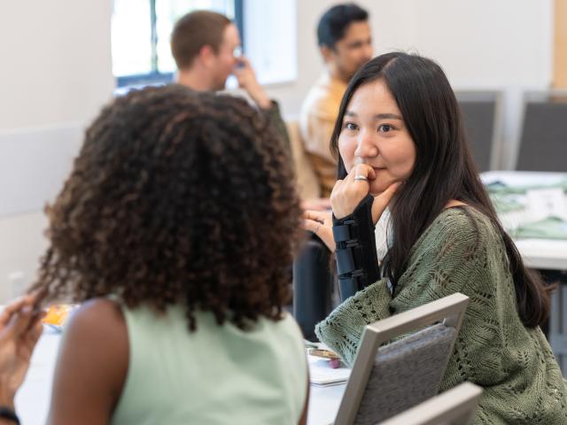 EPM orientation photo of two students talking.