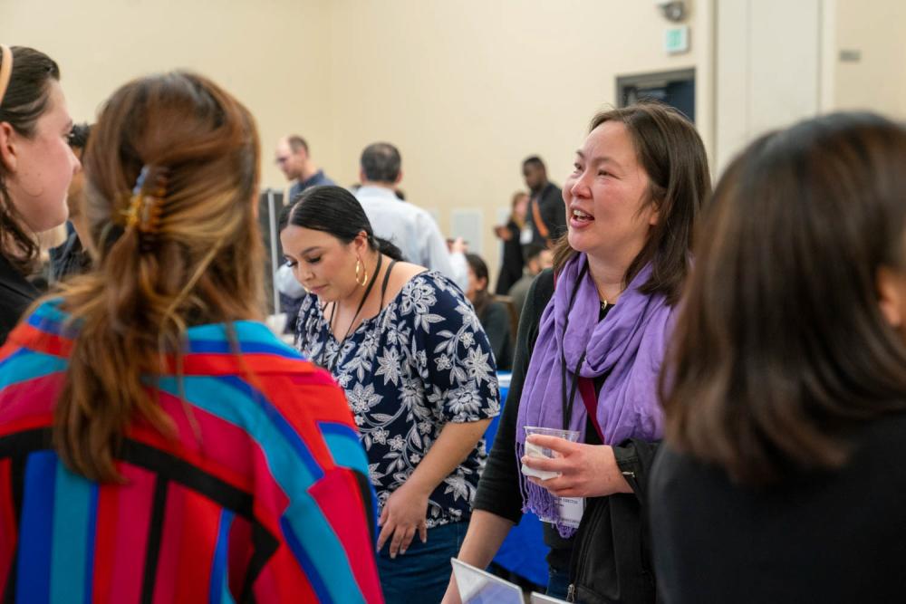 Photo of people talking in a busy room