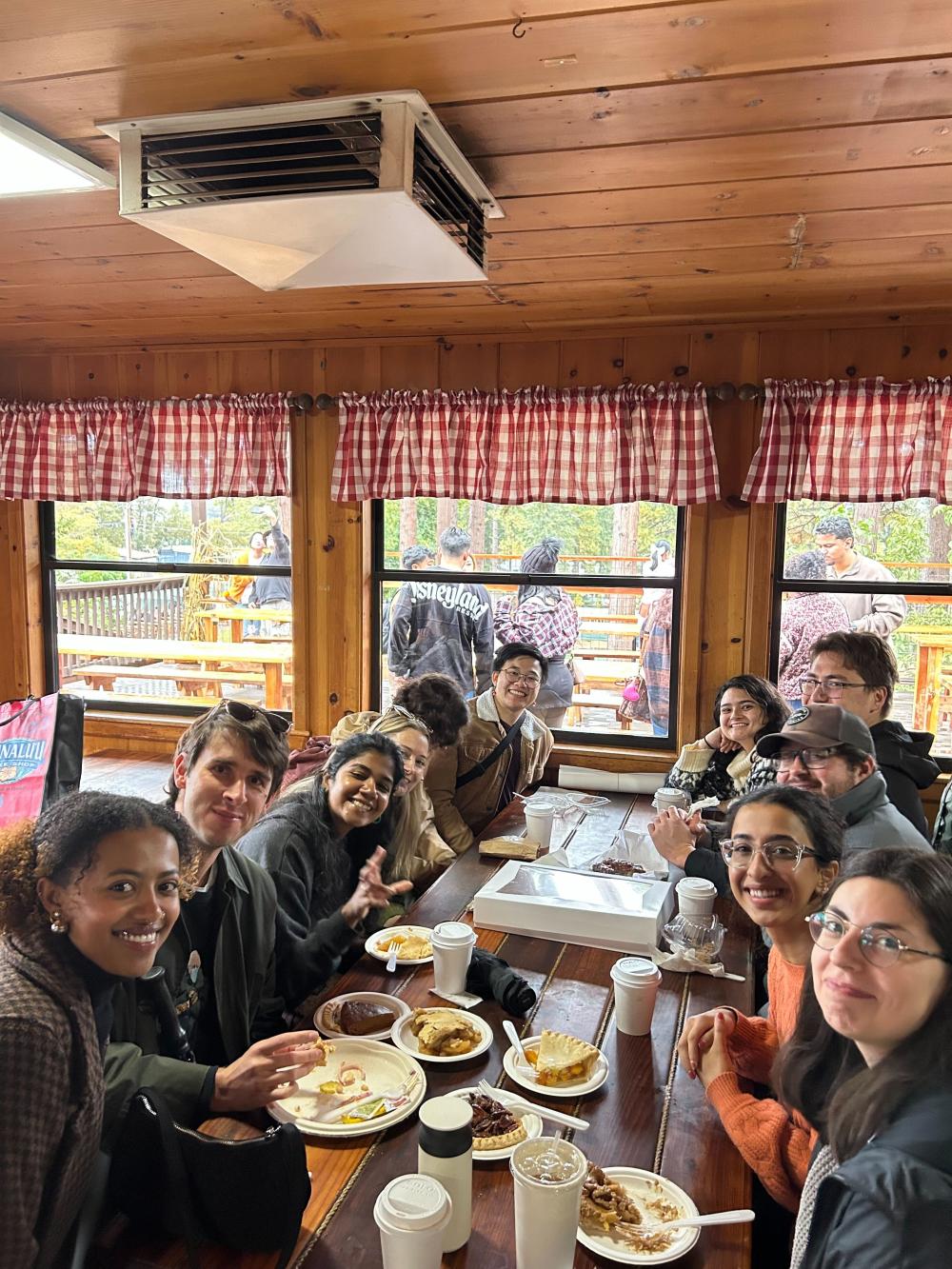 EPM students sitting around a table enjoying fall foods!