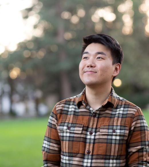 Bilegt Baatar featured smiling with greenery and trees in the background.