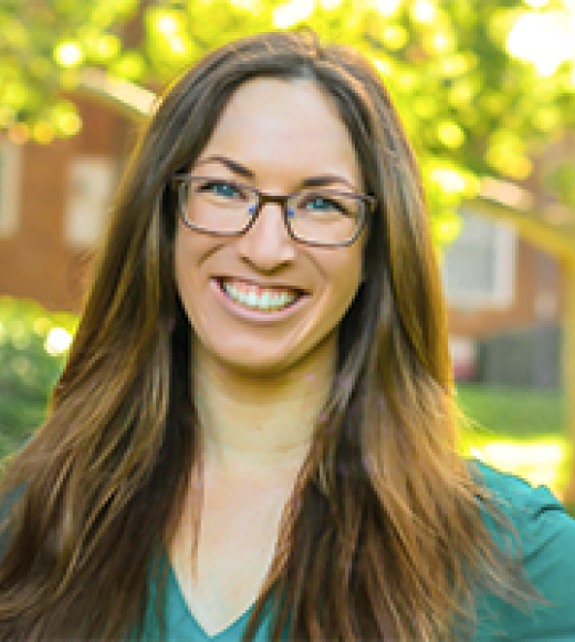 Kaitlyn Kalua featured smiling in front of buildings.