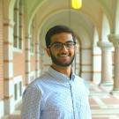 Saurabh Harohalli smiling featured in an outside hallway