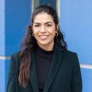 Erin Rodriguez featured smiling in front of a blue wall.