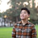 Bilegt Baatar featured smiling with greenery and trees in the background.