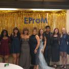 EPM social committee featured in front of a photo backdrop