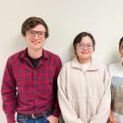 Liam Huber, JieQi Yan, and Tara Khan featured in front of a white wall.