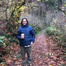 Eric Post standing on a wooded area.