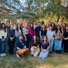 Pictured is the 2023 Incoming Class of Environmental Policy students featured in front of a tree outside of Walker Hall, on campus.