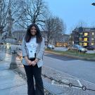 Kriti Shah featured smiling in front of some buildings in Italy