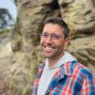 Ryan Meyer outside in front of a rock formation.