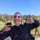Erica Parker smiling with binoculars in her hand.