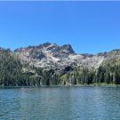 A kayaker enjoys Lower Sardine Lake beneath the majestic Sierra Buttes, in Plumas National Forest, North State, California
